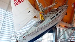At the far end of the Museum near the water is a large yacht tilted at an extreme angle, a mannequin clinging to the mast.