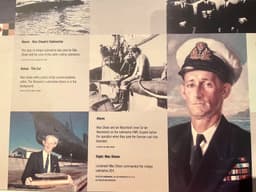 The oil painting of Max Shean stands out among the text and photos of this display panel.