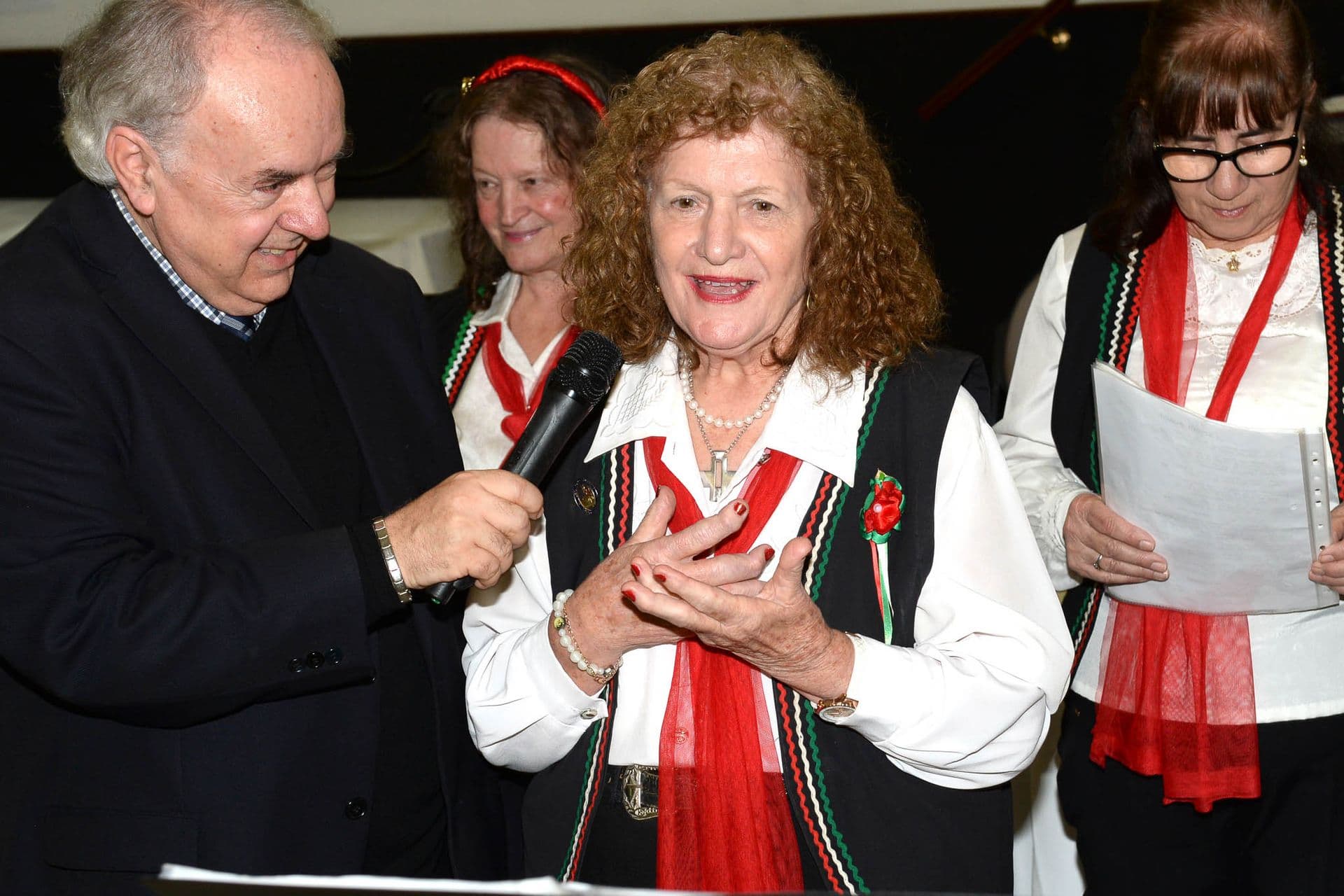 Vincenza speaks passionately into a microphone.