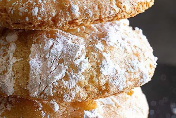 close up image of biscotti dusted in icing sugar